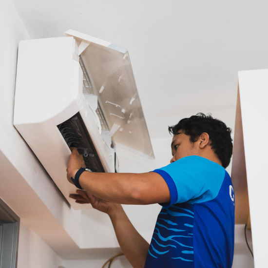 Technician Installing Air Conditioner